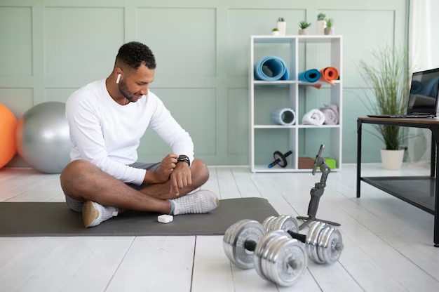 A man sitting on a rug checks his watch