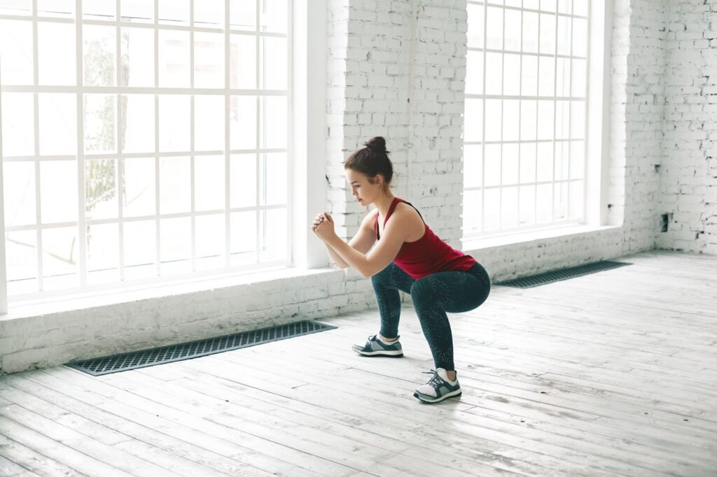 Woman doing squats in gym