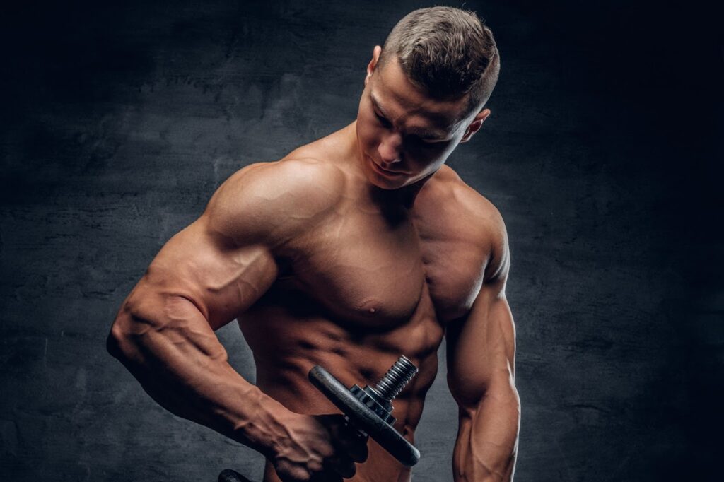 Athletic male doing biceps workouts with one dumbbell