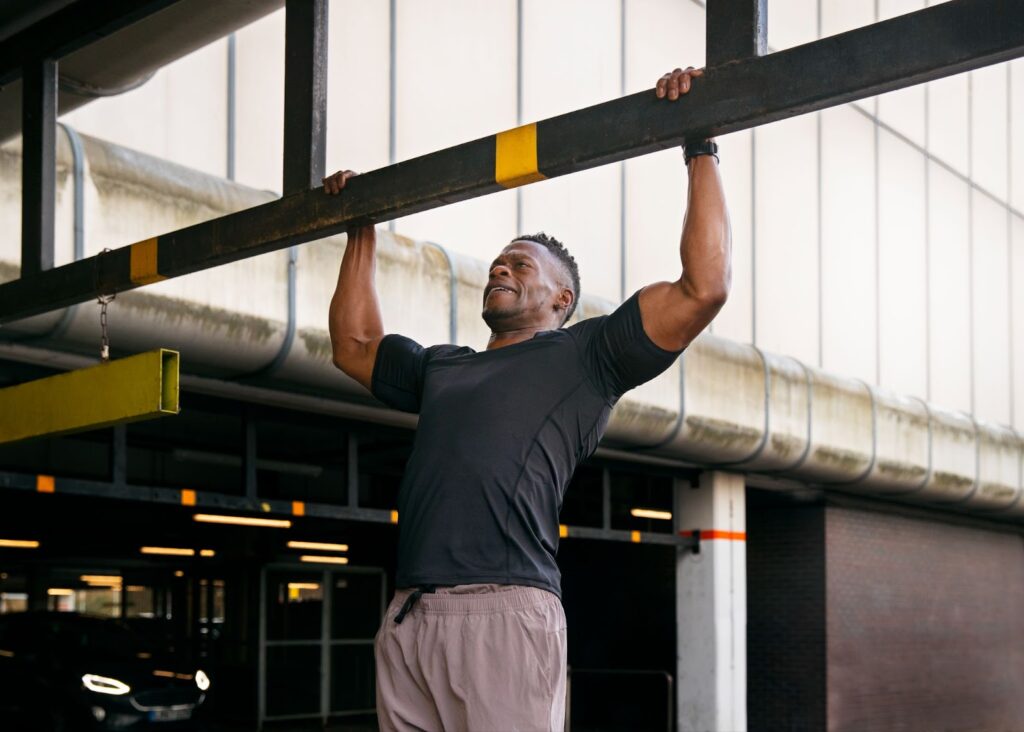 Man doing pull ups outdoors