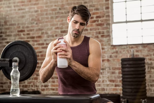 Man at the gym mixing creatine